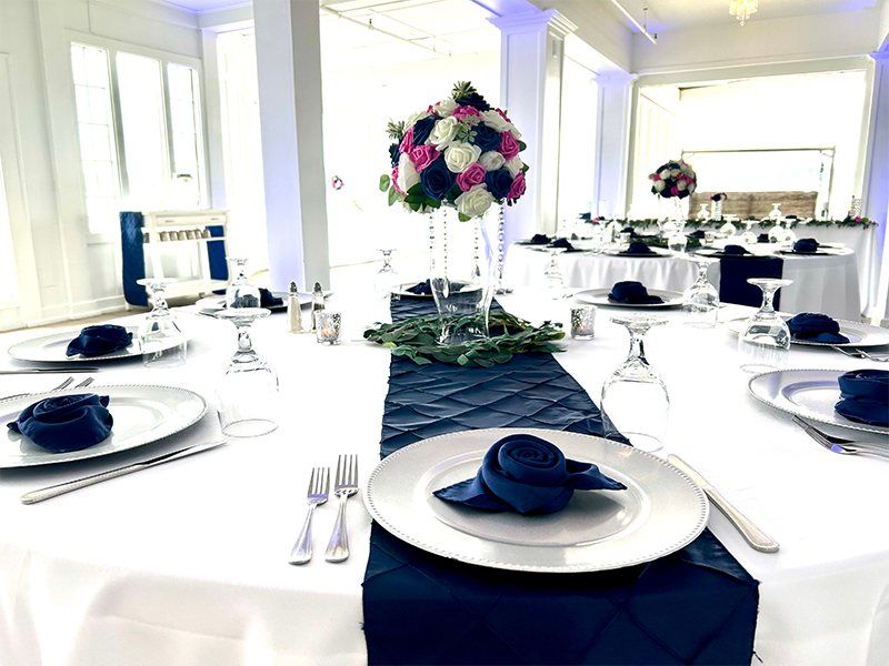 Table setting in royal blue and white at premiere event venue for parties, corporate events, retirement, birthdays, and more